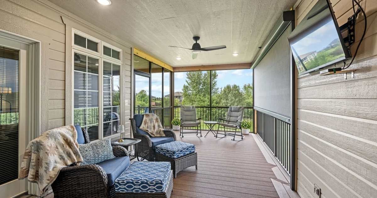 Image of a screened in patio with furniture and a television by Fox Home Innovations in Manhattan KS