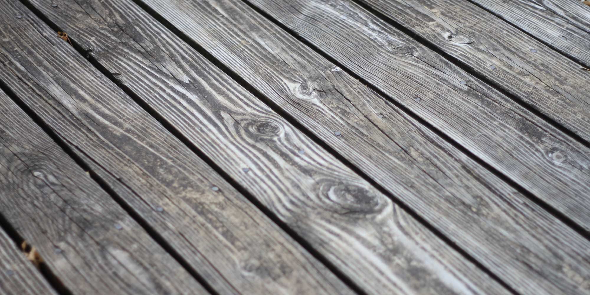 Stock Image of old weathered wood on a deck that needs replaced