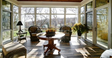 Interior of a sunroom remodel with new floor-to-ceiling windows and a glass door by Fox Home Innovations in Manhattan, KS