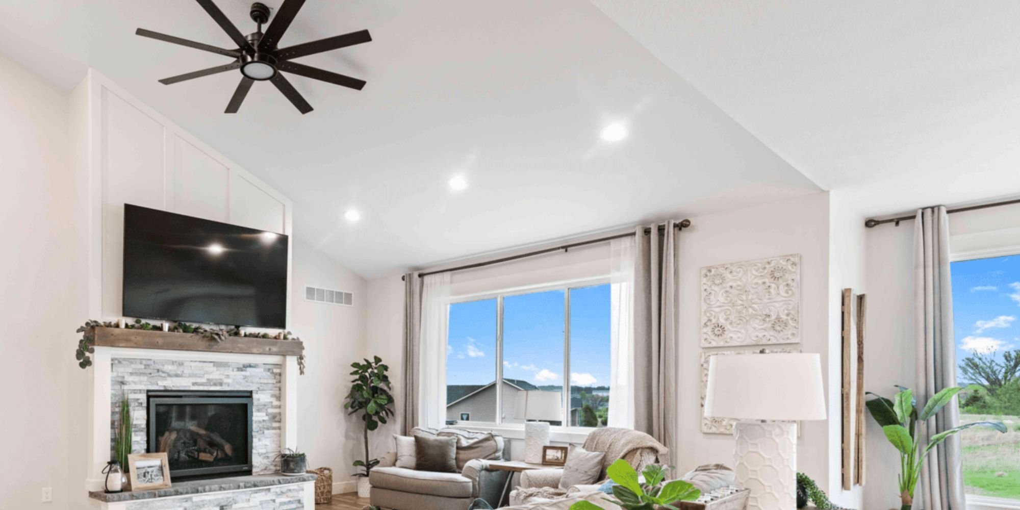 A living room remodel featuring large new windows and a fireplace by Fox Home Innovations in Manhattan, KS