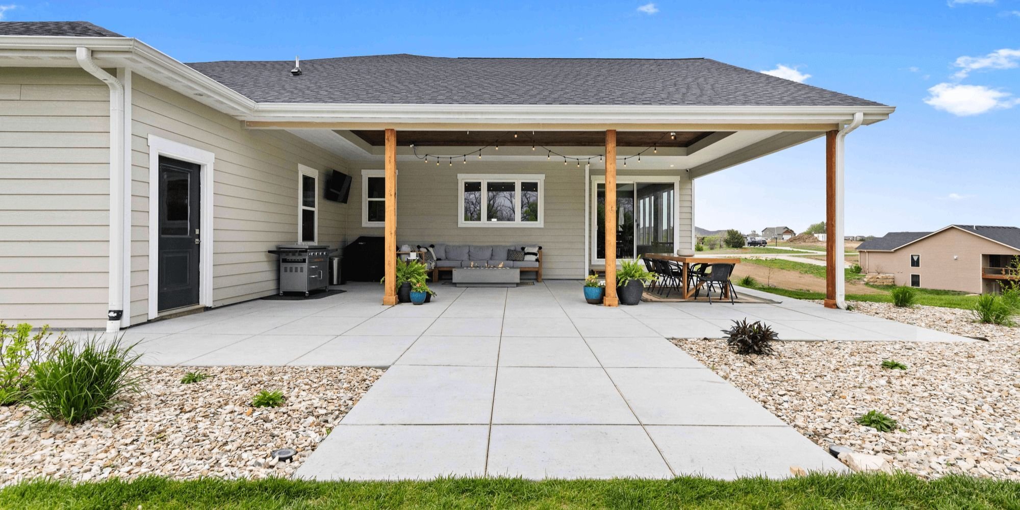 Covered patio remodel with natural wood pillars and upgraded windows by Fox Home Innovations in Manhattan, KS
