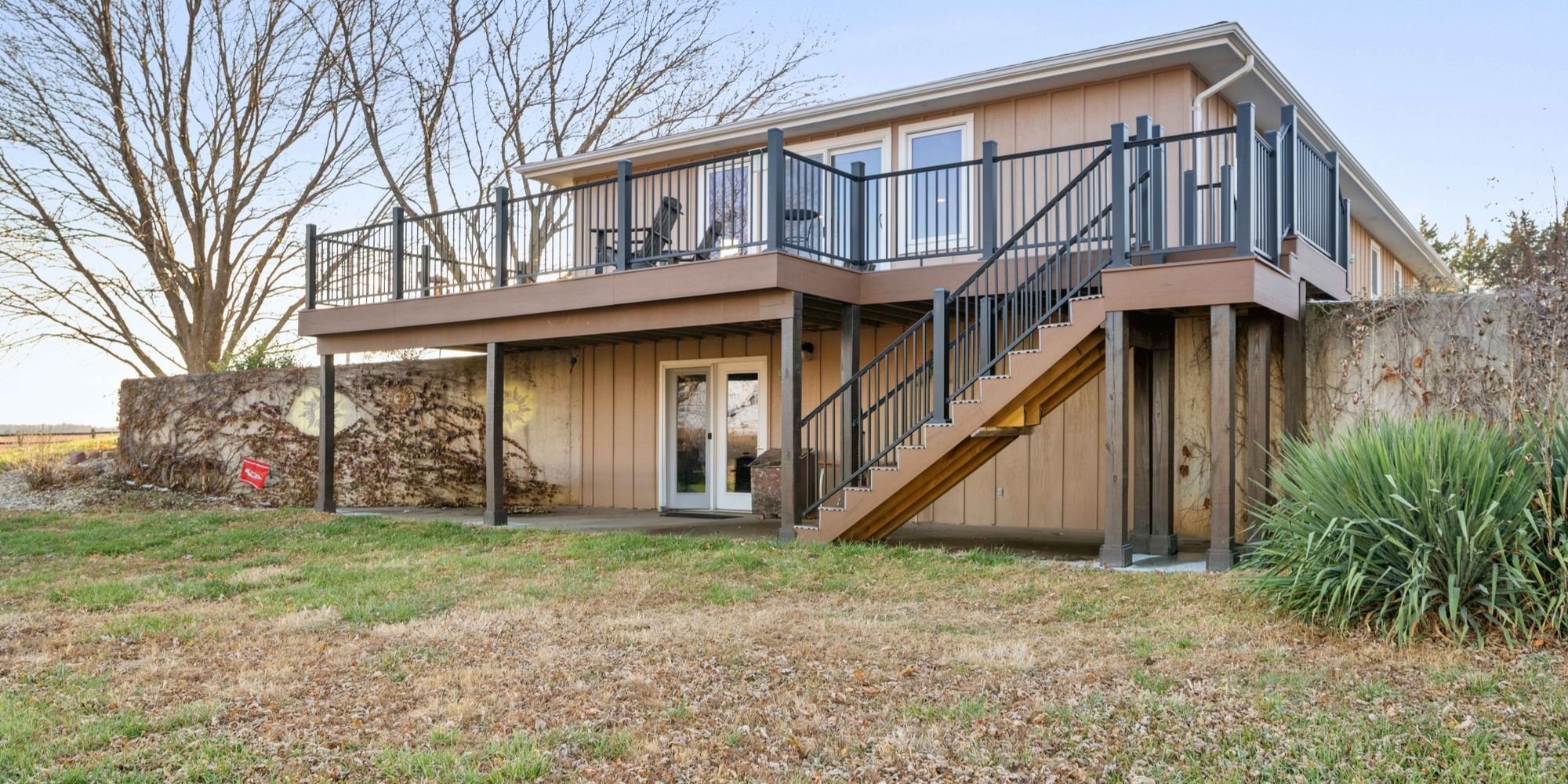 Exterior home remodel with a second-story deck, new siding, and new windows in Manhattan, KS by Fox Home Innovations
