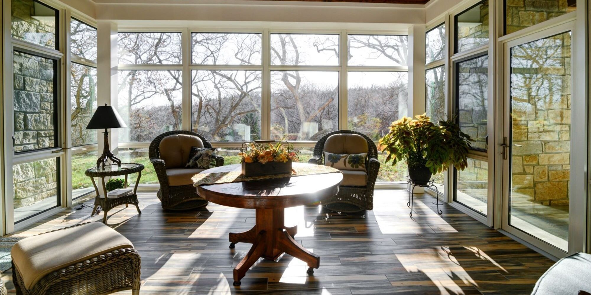 Interior of a sunroom remodel with new floor-to-ceiling windows and a glass door by Fox Home Innovations in Manhattan, KS