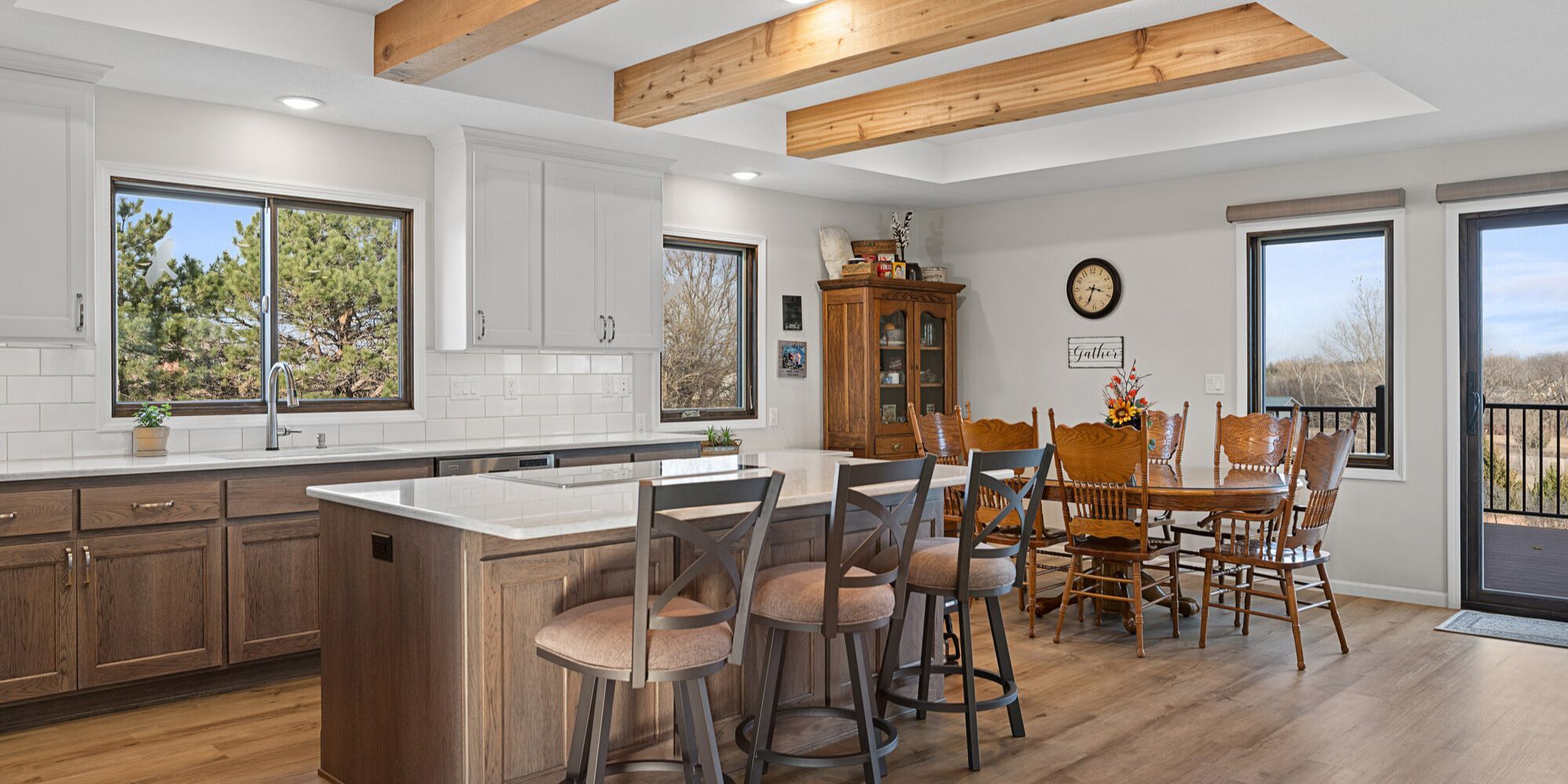 Open-concept kitchen remodel with a seating island, dining area, and two-tone cabinetry by Fox Home Innovations in Manhattan, KS