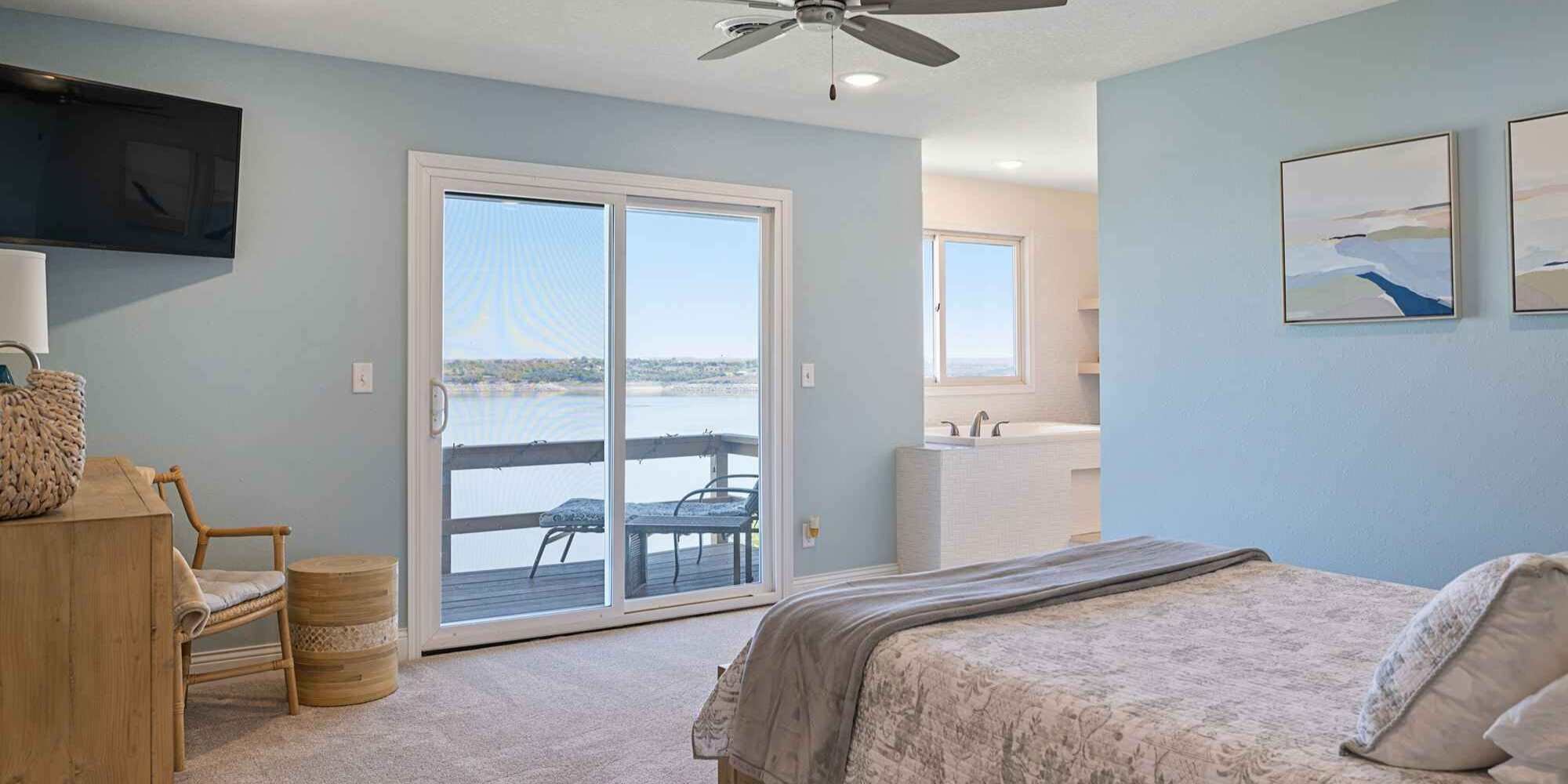A bedroom remodel with a sliding glass door that opens onto a balcony in Manhattan, KS by Fox Home Innovations