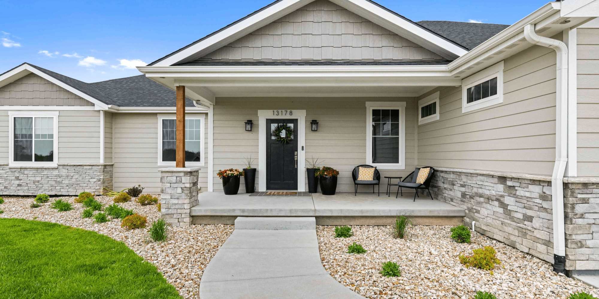 Front exterior view of a home remodel with new windows and door in Manhattan, KS by Fox Home Innovations