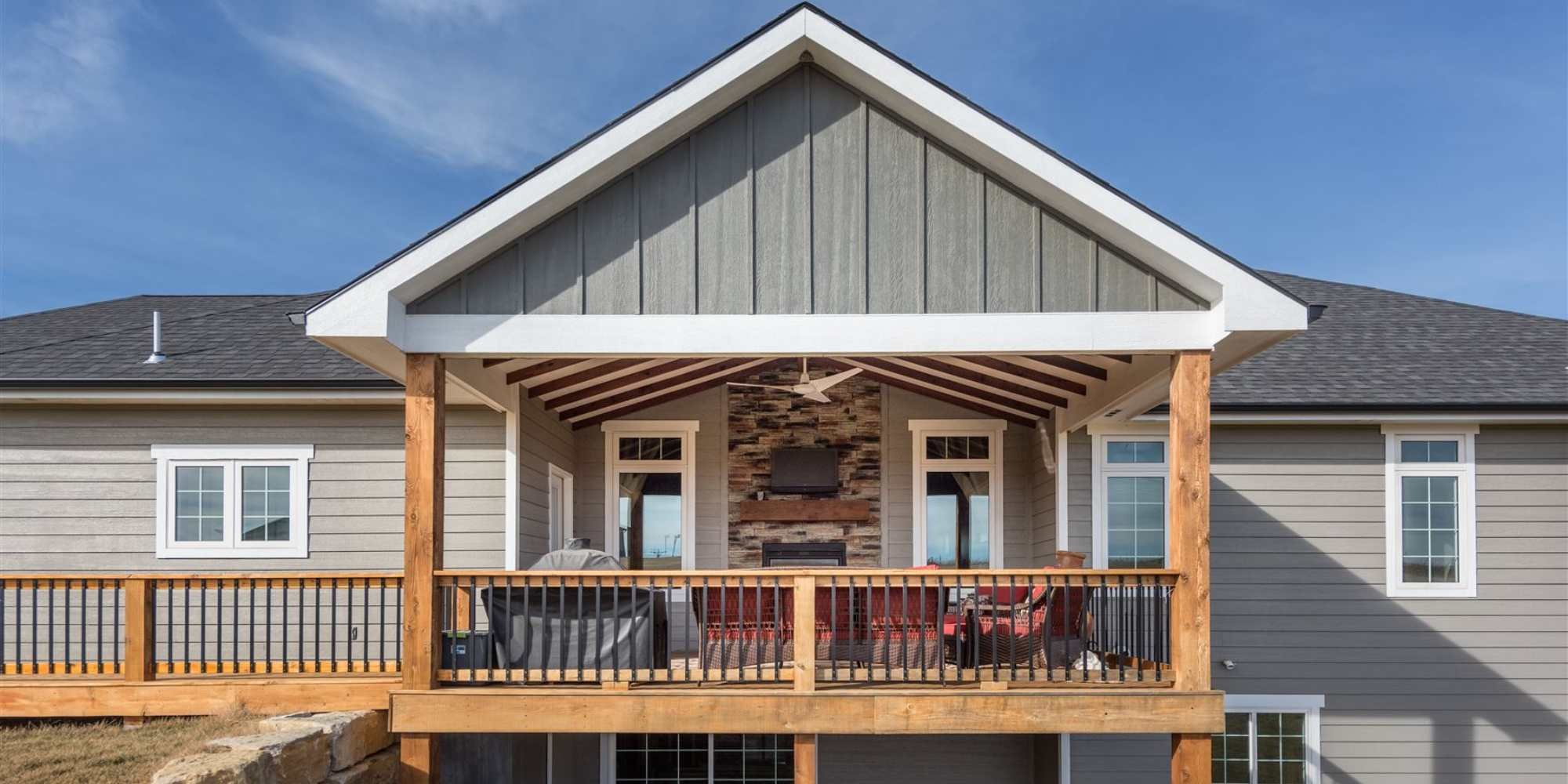 Front view of a remodeled home with a porch and new siding in Manhattan, KS by Fox Home Innovations