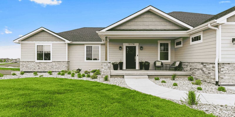 Image of the front exterior of a home remodel with new windows and door in Manhattan, KS by Fox Home Innovations