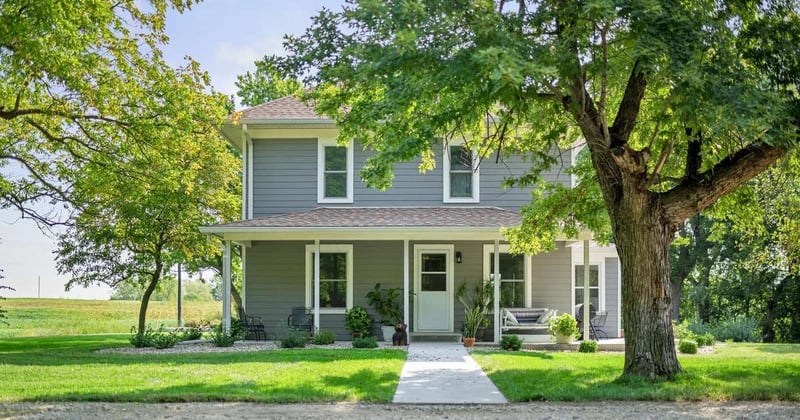 Image of the front exterior of a home with new siding, windows, and front door by Fox Home Innovations in Manhattan, KS