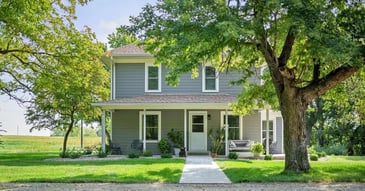 Image of the front exterior of a home with new siding, windows, and front door by Fox Home Innovations in Manhattan, KS