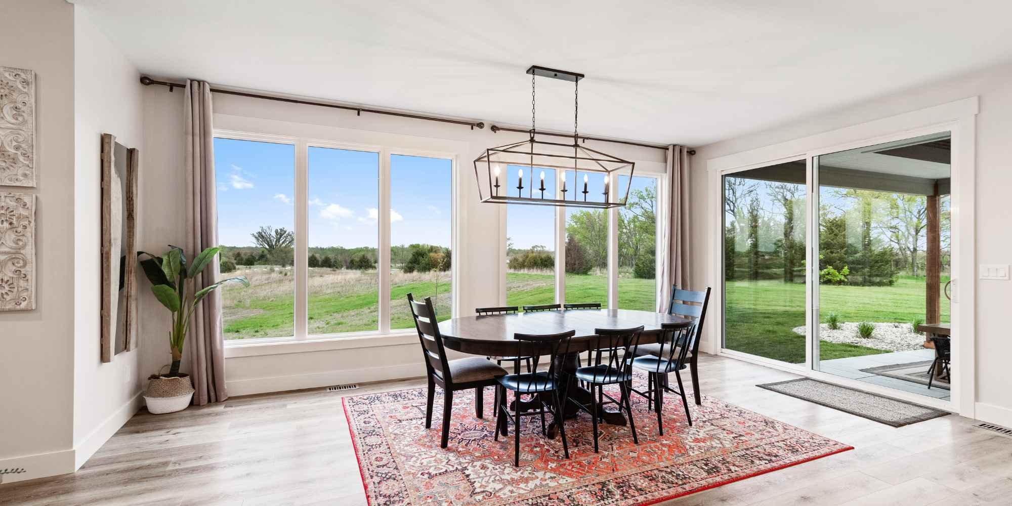 A bright dining room with large windows by Fox Home Innovations in Manhattan, KS