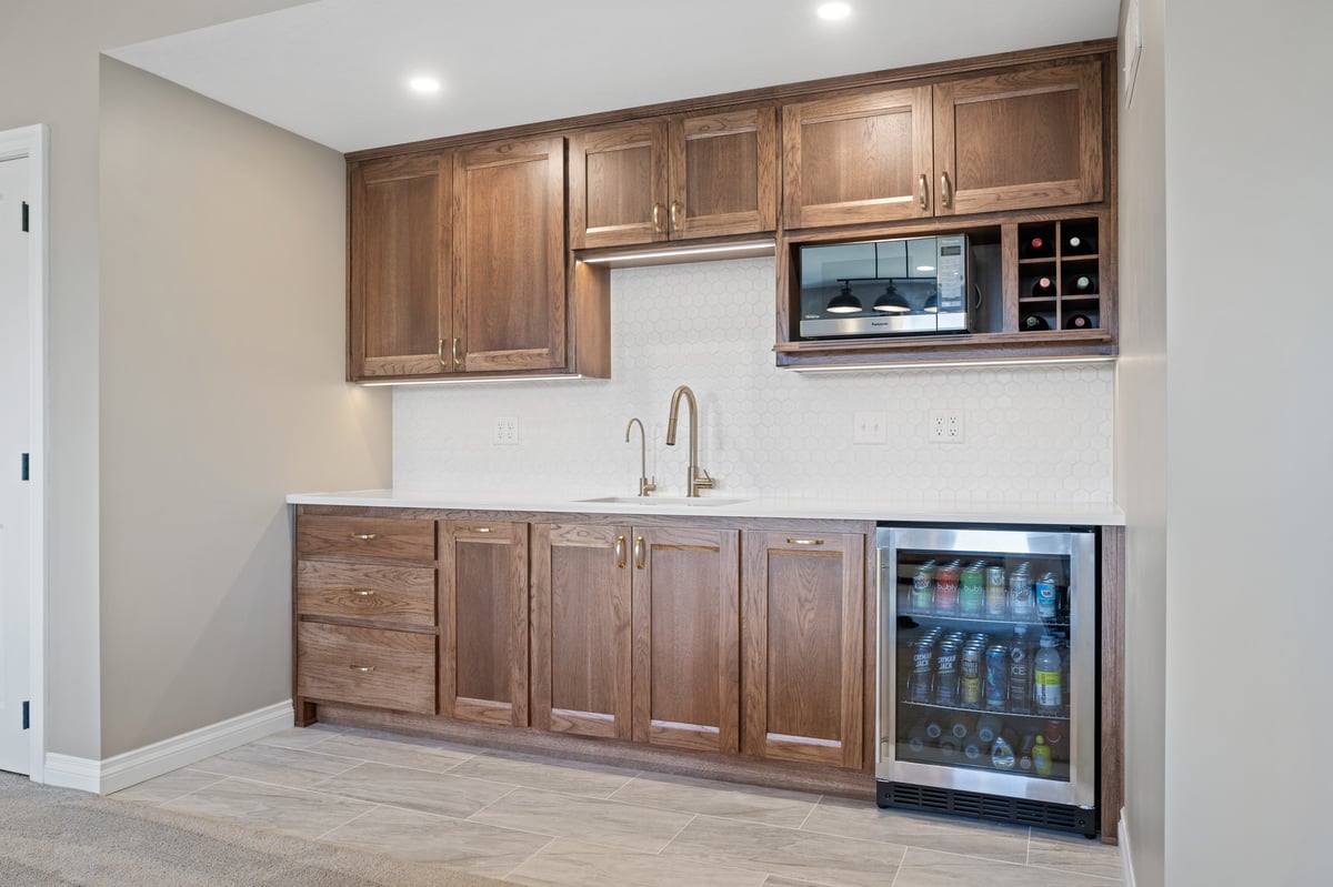 basement home bar remodel in manhattan kansas with wine fridge and dark cabinets