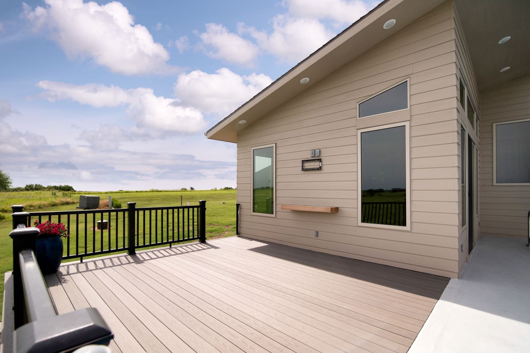 A refinished deck overlooking a field in Manhattan, KS by Fox Home Innovations