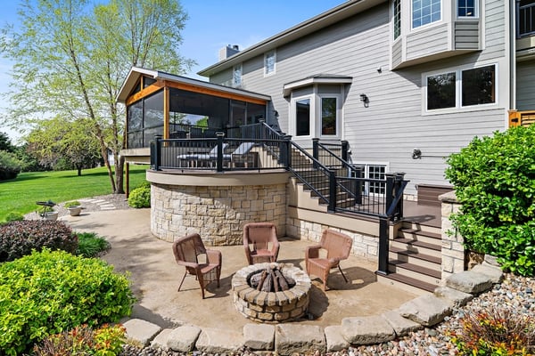 Backyard area with a deck, patio and fire pit. 