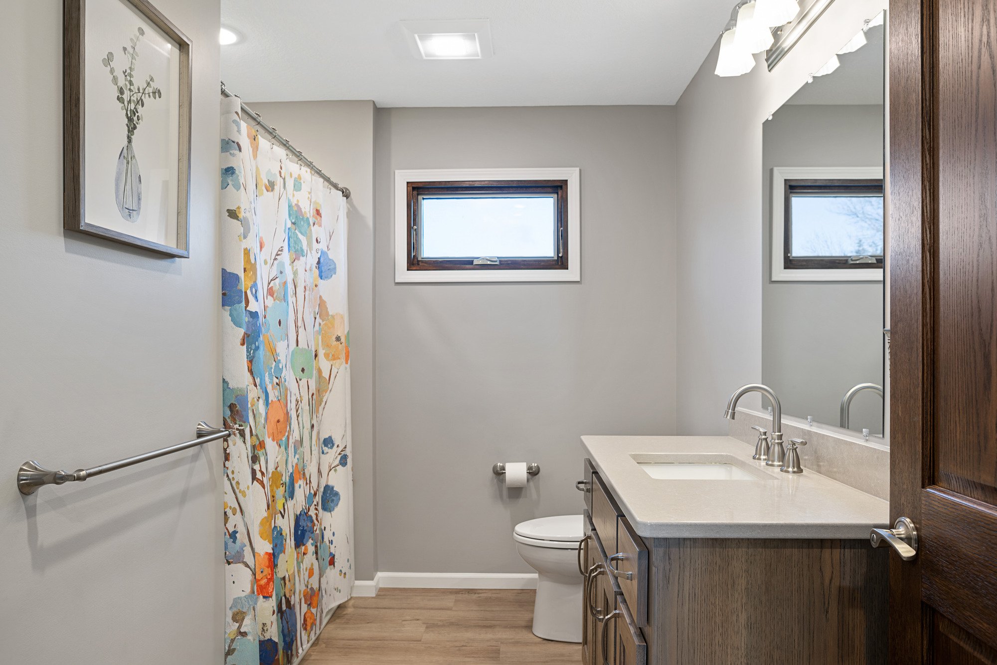 bathroom remodel with gray walls and white vanity top