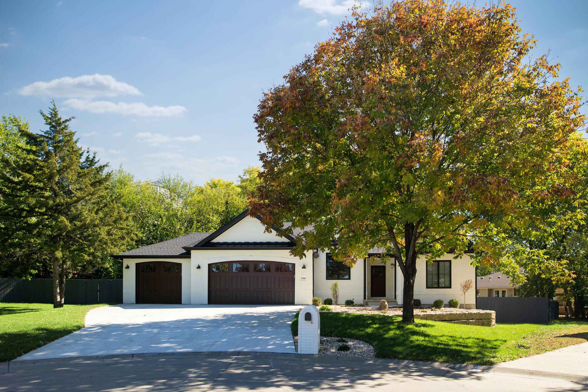 a home addition in manhattan kansas showing the front extioror home with dark colored garage door